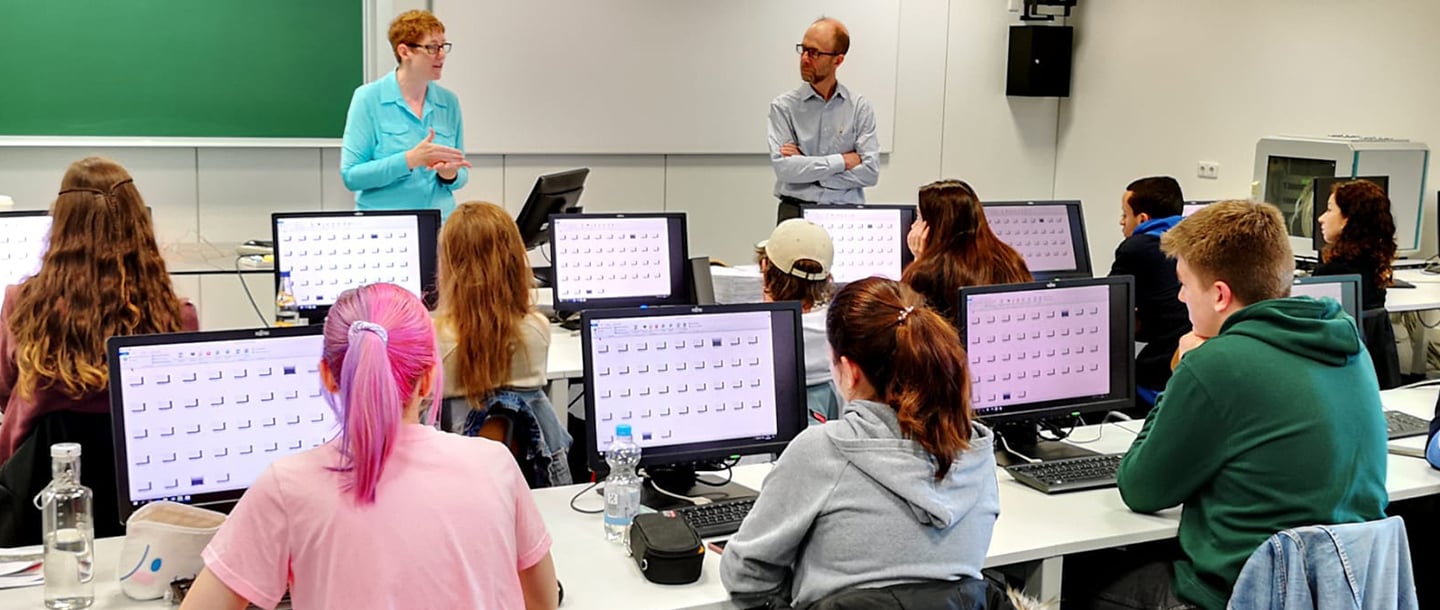 Dr. Tesdell and Dr. Armfield teaching students in a tech-com classroom